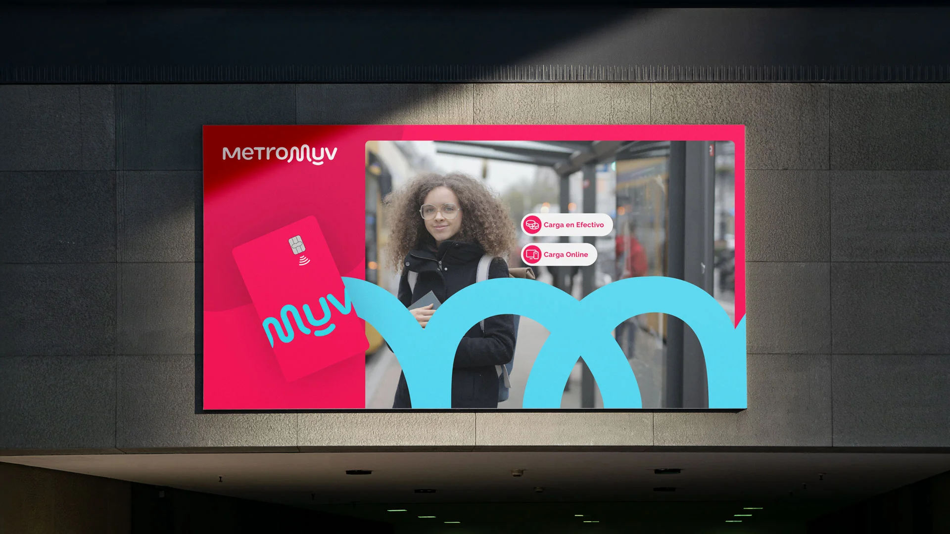 Billboard showing MetroMUV card and a woman with curly hair wearing glasses in city street.