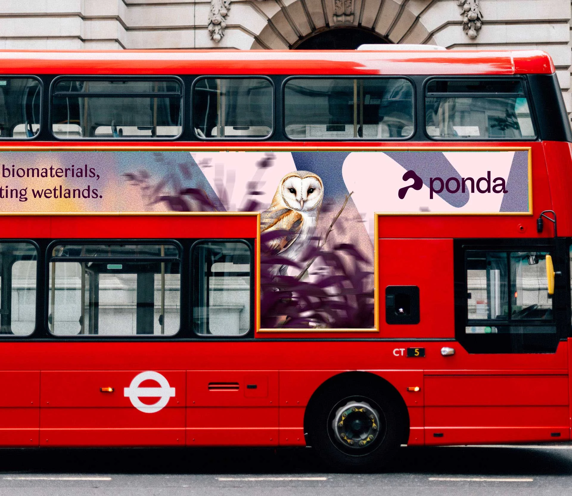 Red double-decker bus with an advertisement featuring a barn owl and the word ponda.